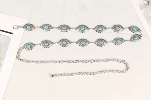 Detail of a silver chain belt featuring bohemian turquoise stone decorative discs.