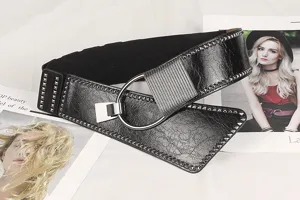 Detail of a wide black punk belt with metal rivets and a stylish ring buckle.