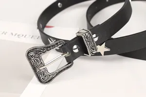 Macro view of vintage engraved silver buckle on black leather belt with star decorations