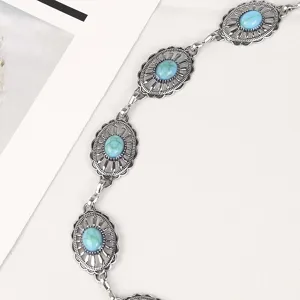 Detail shot of vintage silver metal chain belt with turquoise stones