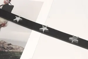 Close-up detail of a black Y2K vintage style leather belt with silver star studs