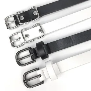 Detail view of slim black and white leather belts with various metal buckles