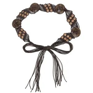 Detail shot of bohemian woven belt featuring coconut shells and patterned wood beads