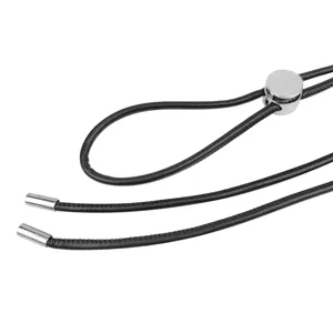Macro detail of black thin cord belt with silver metallic tips and sliding buckle.