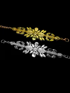 Detailed view of luxury gold and silver rhinestone waist chains on a black background