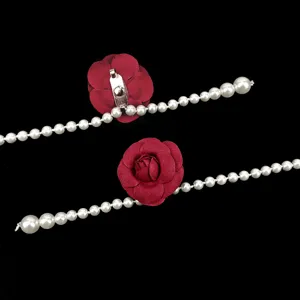 Elegant pearl waist chain featuring detailed red fabric camellia flower charm decorations