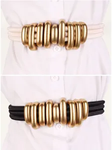 Detailed view of elastic waist belts in beige and black featuring golden metallic rings