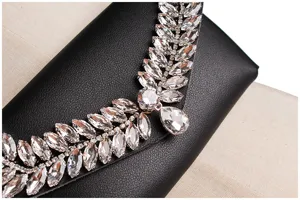 Close-up of sparkling rhinestone arrangement on black leather waist bag detail