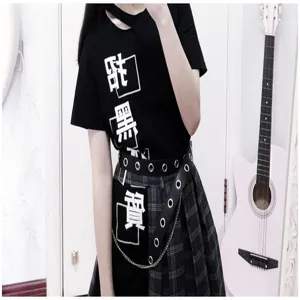 Detail showing a punk-style black belt with silver rivets and decorative chain on a skirt.