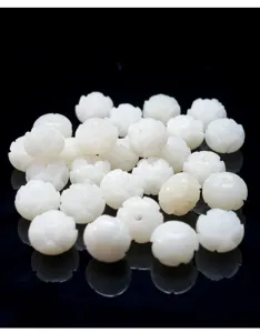 Macro detail of white carved Bodhi root lotus beads used for jewelry making