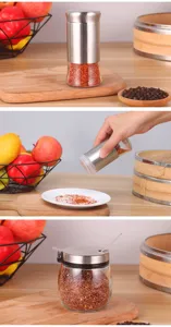 Detail view of high-quality stainless steel and glass seasoning jars for kitchen.