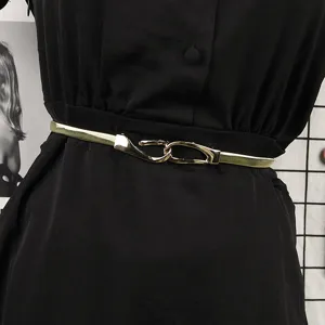 Close-up of a stylish gold elastic metal belt for women on a black dress