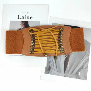 Detailed macro view of brown elastic corset belt with yellow lace-up design