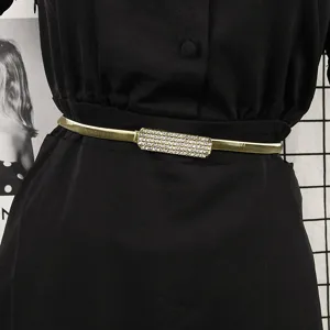 Elegant gold elastic metal waist belt with a sparkly rhinestone buckle for women's dresses