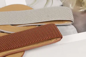 Close-up detail of punk style elastic wide waist seal with textured rivet-like pattern.