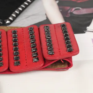 Red punk style wide elastic corset belt with square metal rivets detail for women