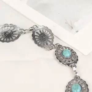 Vintage silver metal chain belt with turquoise floral accents for bohemian fashion.