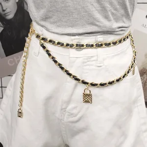 Detail of double-layer braided chain belt with a gold-tone quilted lock pendant on white denim.