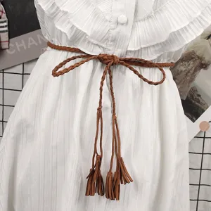 Macro detail of a retro brown braided rope waist belt featuring stylish tassel ends
