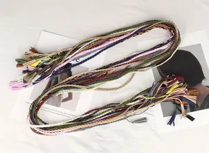 Detailed view of colorful handmade braided waist ropes with decorative tassel ends