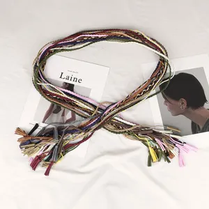 Detailed view of multi-colored braided waist rope with decorative tassels for dresses