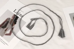 Detail view of a vintage gray braided waist rope with decorative tassels for dresses