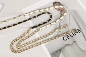 Detailed view of layered gold metal waist chain with woven leather accents for women.