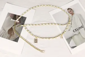Detailed view of a gold double-layer chain belt with white weaving and lock charms.