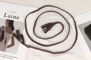 Detailed view of a retro brown braided waist rope with stylish tassels for dresses