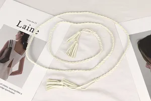 Close-up of a white vintage braided waist rope belt with tassels for dresses and sweaters.