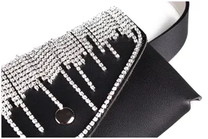 Close-up detail of black faux leather waist bag featuring sparkling rhinestone fringe