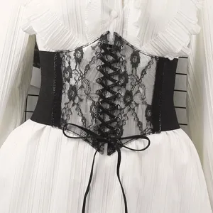 Detailed view of a wide black lace-up elastic corset belt for dresses.
