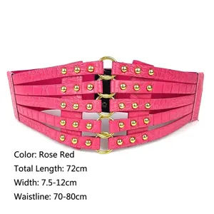 Close-up of rose red wide elastic waist belt featuring gold studs and metal ring buckle