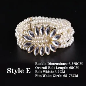 Detail view of pearl elastic belt featuring a sparkling rhinestone flower buckle