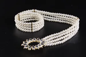 Detailed view of an elegant four-row pearl elastic belt with crystal flower buckle