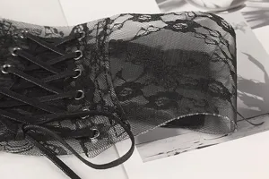 Macro detail of black floral lace waist belt with criss-cross ribbon lace-up design