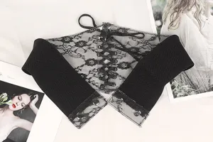 Detailed view of black lace corset belt with elastic band and lace-up front design