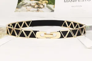 Detail shot of women's elastic skinny belt with gold triangle metal buckle.