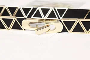 Close-up of golden metal triangle decoration and hook buckle on black elastic belt