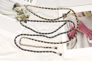 Detail view of stylish gold and silver multi-layer metal chain waist belts for dresses.