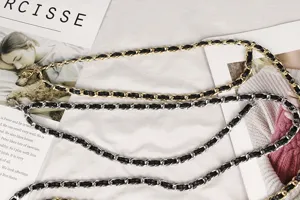 Close-up of braided gold and silver metal waist chains for dress accessories.