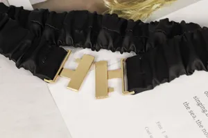 Detaillierte Nahaufnahme: schwarzer elastischer Taillengürtel mit goldener Schnalle