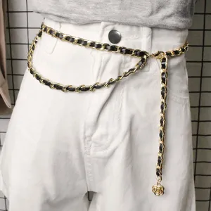 Close-up view of a double-layered gold chain waist belt with black leather weaving detail.