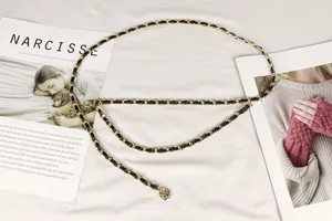 Detailed view of double-layer metal chain waist belt with black leather and camellia pendant