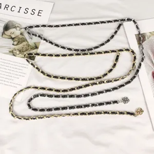 Multi-layer metal waist chain with interwoven leather and floral charms for dresses.
