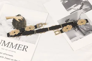 Detailed view of elegant gold floral metal patterns on a black elastic dress belt