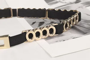 Close-up detail of black elastic waist belt with elegant gold O-ring metal decorations
