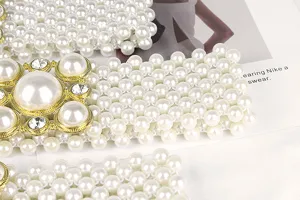 Close-up of elegant white pearl beaded belt with a large rhinestone and pearl buckle