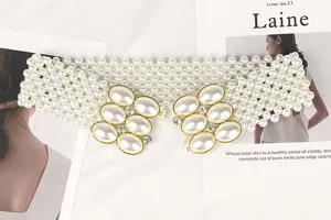 Detailed view of wide elastic pearl belt featuring rhinestone and large oval pearl buckle.