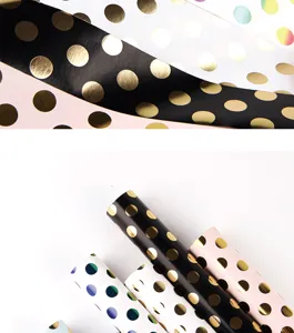 Detailed macro shot of premium gold foil polka dot wrapping paper in various colors